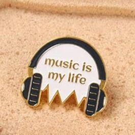 Close-up of Music Is My Life enamel pin showing gold metal frame and butterfly clutch backing