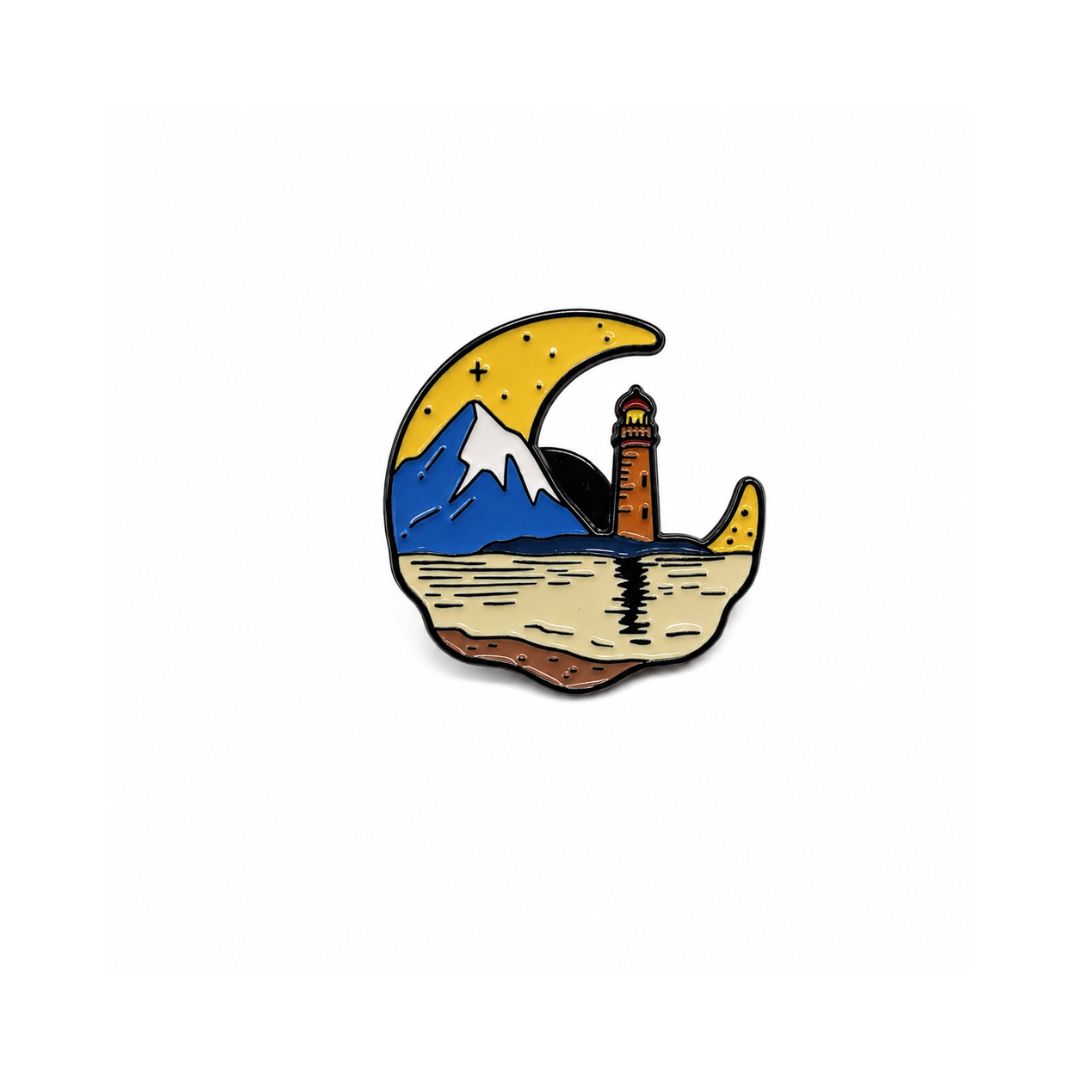 Travel enamel pin featuring lighthouse, mountain landscape and crescent moon design