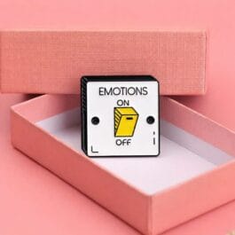 emotions off lapel pin placed inside pink gift box with yellow switch design
