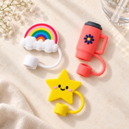 Set of three silicone straw toppers in rainbow, tumbler and smiling-star designs